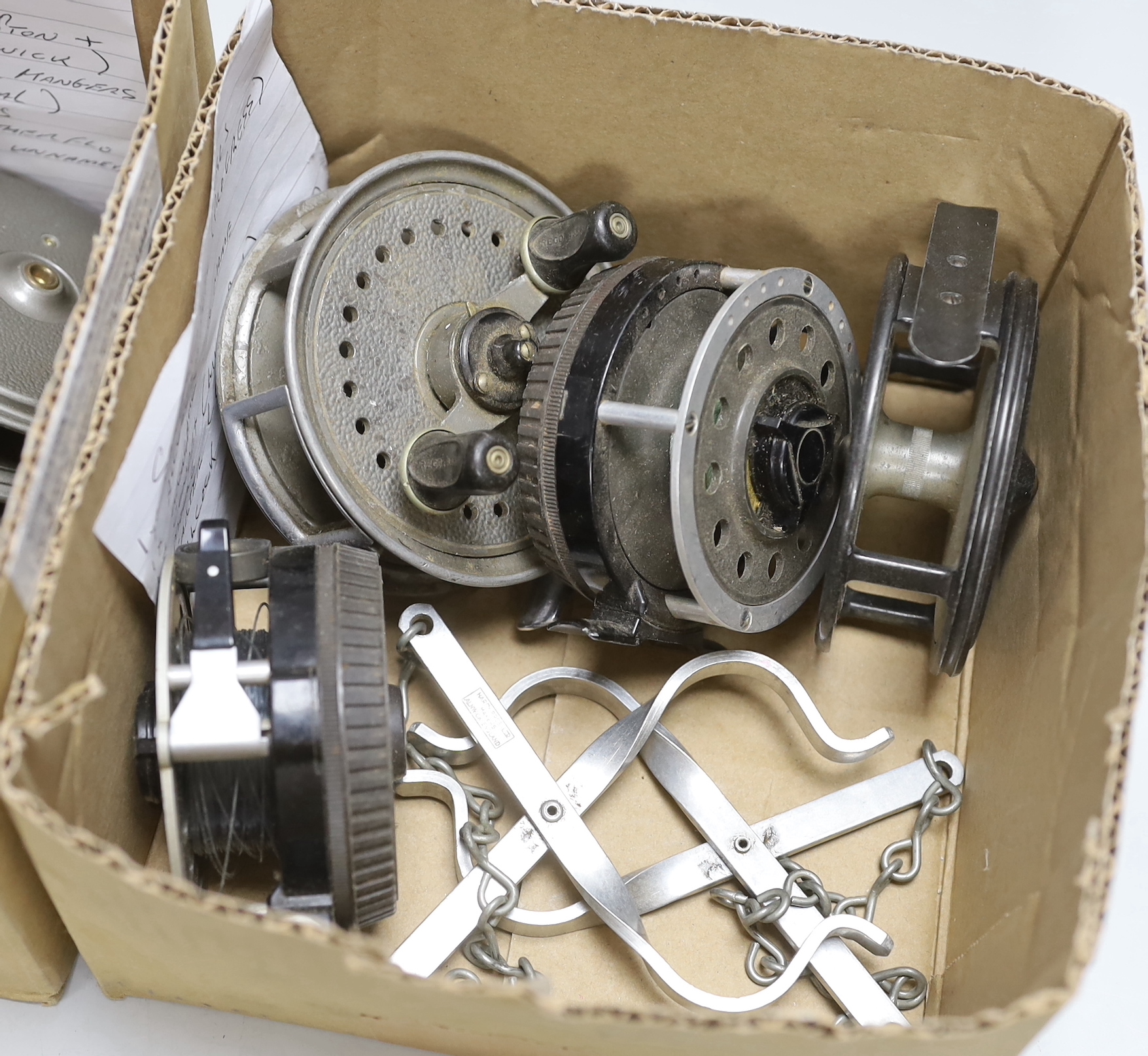 Twelve various fishing reels including a brass and horn handled 4 inch reel and a pair of Hardy wader hangers